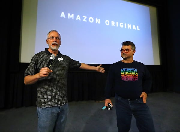 Jim Farmer (right), director of the Out on Film Festival, and his husband Craig Hardesty, board chair, address the audience at the Landmark Midtown Art Cinema before a preview of two episodes of "A League of Their Own," a streaming remake of the Penny Marshall movie in August. “Curtis Compton / Curtis Compton@ajc.com