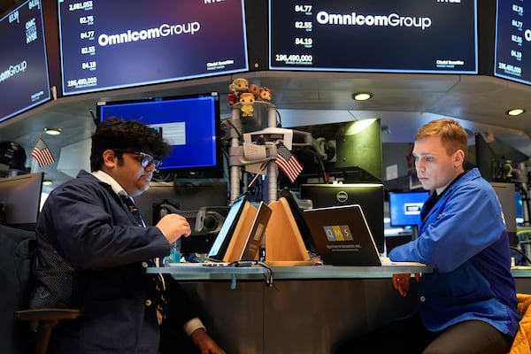 People work on the floor at the New York Stock Exchange in New York, Monday, Feb. 24, 2025. (AP Photo/Seth Wenig)