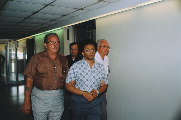 Wayne Williams, the suspect being detained in Atlanta murders, being led in handcuffs.