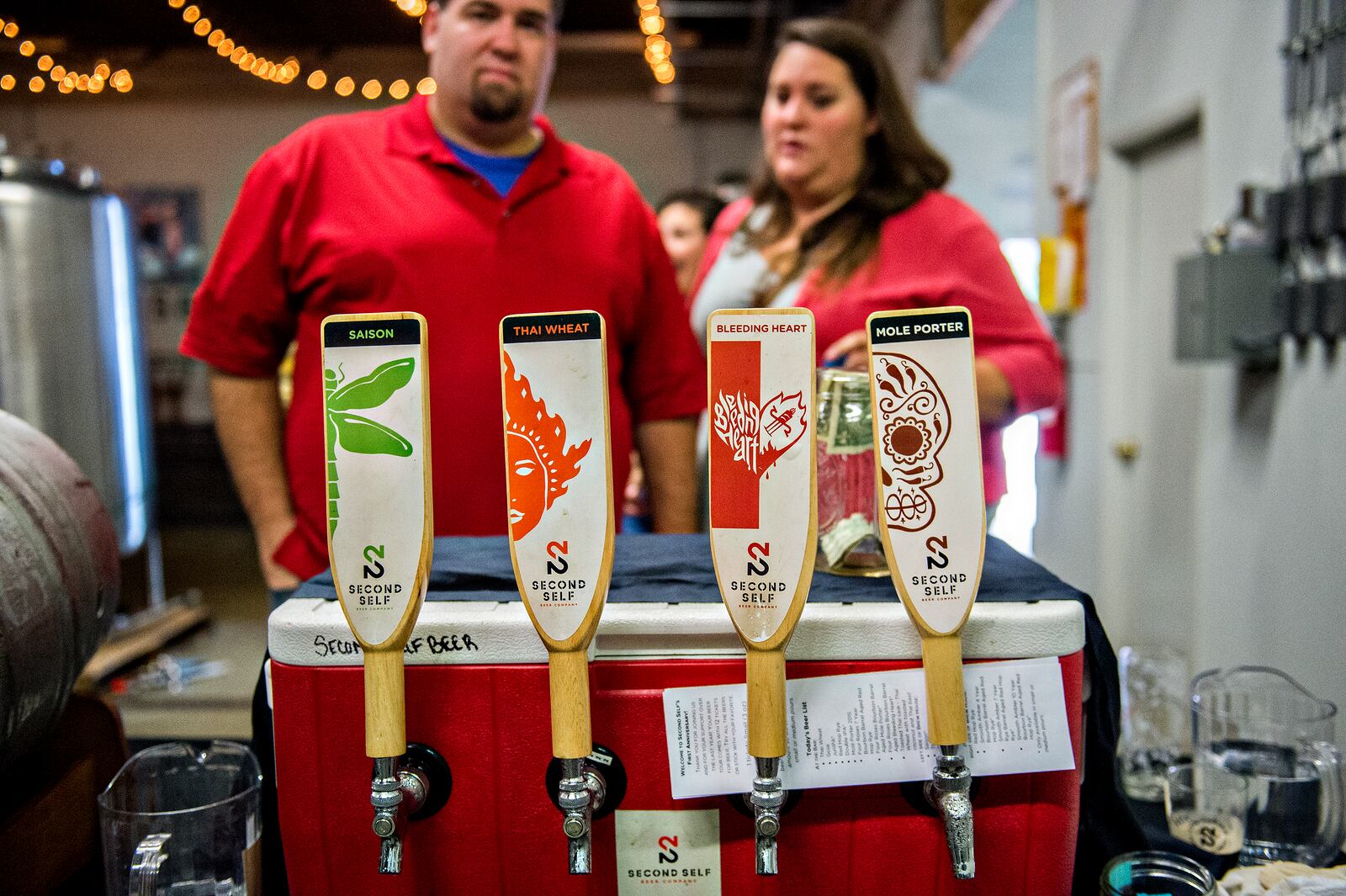 October 3, 2015 Atlanta - Austin Little (left) and Leslie Klein decide what beer to try during the Second Self Beer Company's one year anniversary celebration in Atlanta on Saturday, October 3, 2015. The brewery had 16 different beers to sample during the celebration. JONATHAN PHILLIPS / SPECIAL