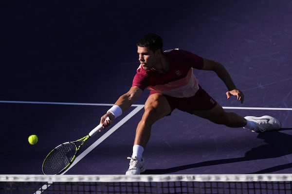 Carlos Alcaraz, of Spain, returns to Jack Draper, of Great Britain, during their semifinals match at the BNP Paribas Open tennis tournament Saturday, March 15, 2025, in Indian Wells, Calif. (AP Photo/Mark J. Terrill)