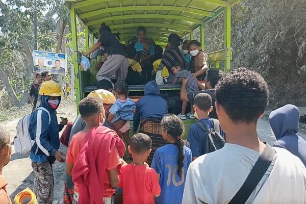 In this image made from AP video, people board a truck as they evacuate their village in an area affected by the eruption of Mount Lewotobi Lake-Laki in East Flores, Indonesia, Tuesday, Nov. 5, 2024. (AP Photo)