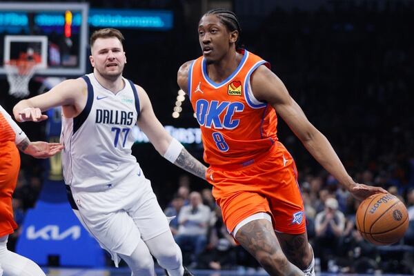 Oklahoma City Thunder forward Jalen Williams (8) drives in front of Dallas Mavericks guard Luka Doncic (77) during the first half of an Emirates NBA Cup basketball game, Tuesday, Dec. 10, 2024, in Oklahoma City. (AP Photo/Nate Billings)