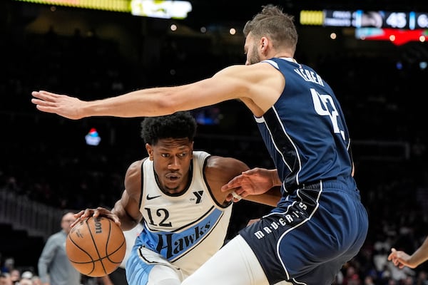 Atlanta Hawks forward De'Andre Hunter (12) moves against Dallas Mavericks forward Maxi Kleber (42) during the first half of an NBA basketball game, Monday, Nov. 25, 2024, in Atlanta. (AP Photo/Mike Stewart)