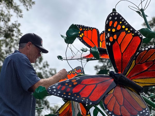 Reno-based artist Peter Hazel works to install "Dancing Monarchs," a sculpture dedicated to former First Lady Rosalynn Carter.