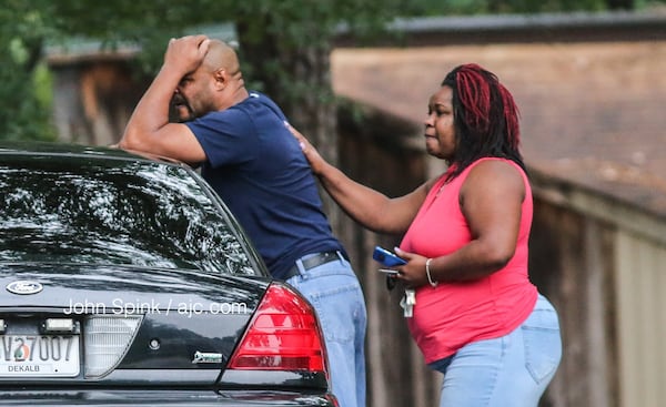 Friends and family were emotional after a triple shooting left two men and a woman dead at a Lithonia apartment Wednesday morning. JOHN SPINK / JSPINK@AJC.COM