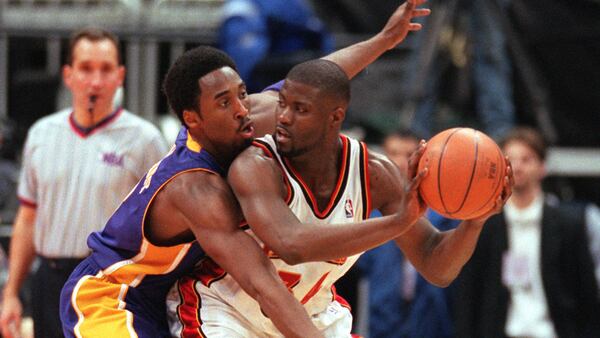 The Lakers' Kobe Bryant closely guards the Hawks' Isaiah Rider in first half Dec. 16, 1999, at Philips arena in Atlanta. Bryant scored 30 points.