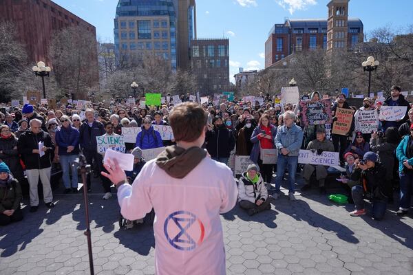 People listen to Griffin Gowdy, a PhD student at Columbia University, speak during a "Stand Up for Science" rally in New York, Friday, March 7, 2025. (AP Photo/Seth Wenig)