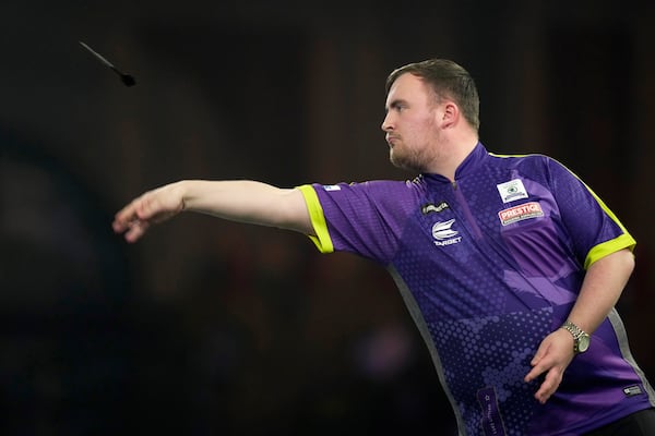 FILE - Luke Littler of England in action during the semifinal match against Rob Cross of England at the World Darts Championship, in London, Tuesday, Jan. 2, 2024. (AP Photo/Kin Cheung, File)