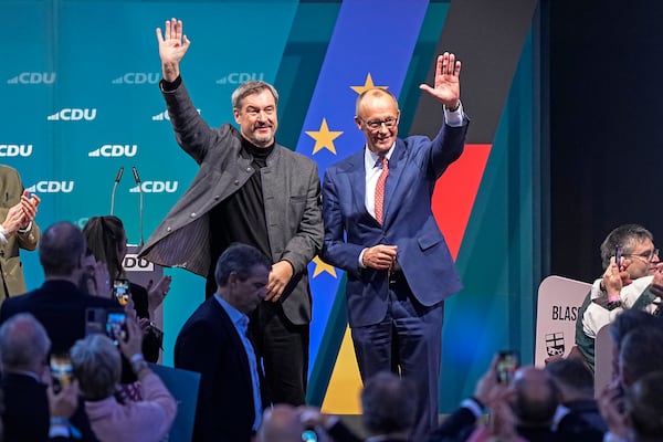 FILE - The top candidate for Chancellor, Friedrich Merz of the Christian Democratic Union (CDU), right, and Bavaria Governor Markus Soeder wave to supporters at a party event in Brilon, Germany, Jan. 19, 2025. (AP Photo/Martin Meissner, File)