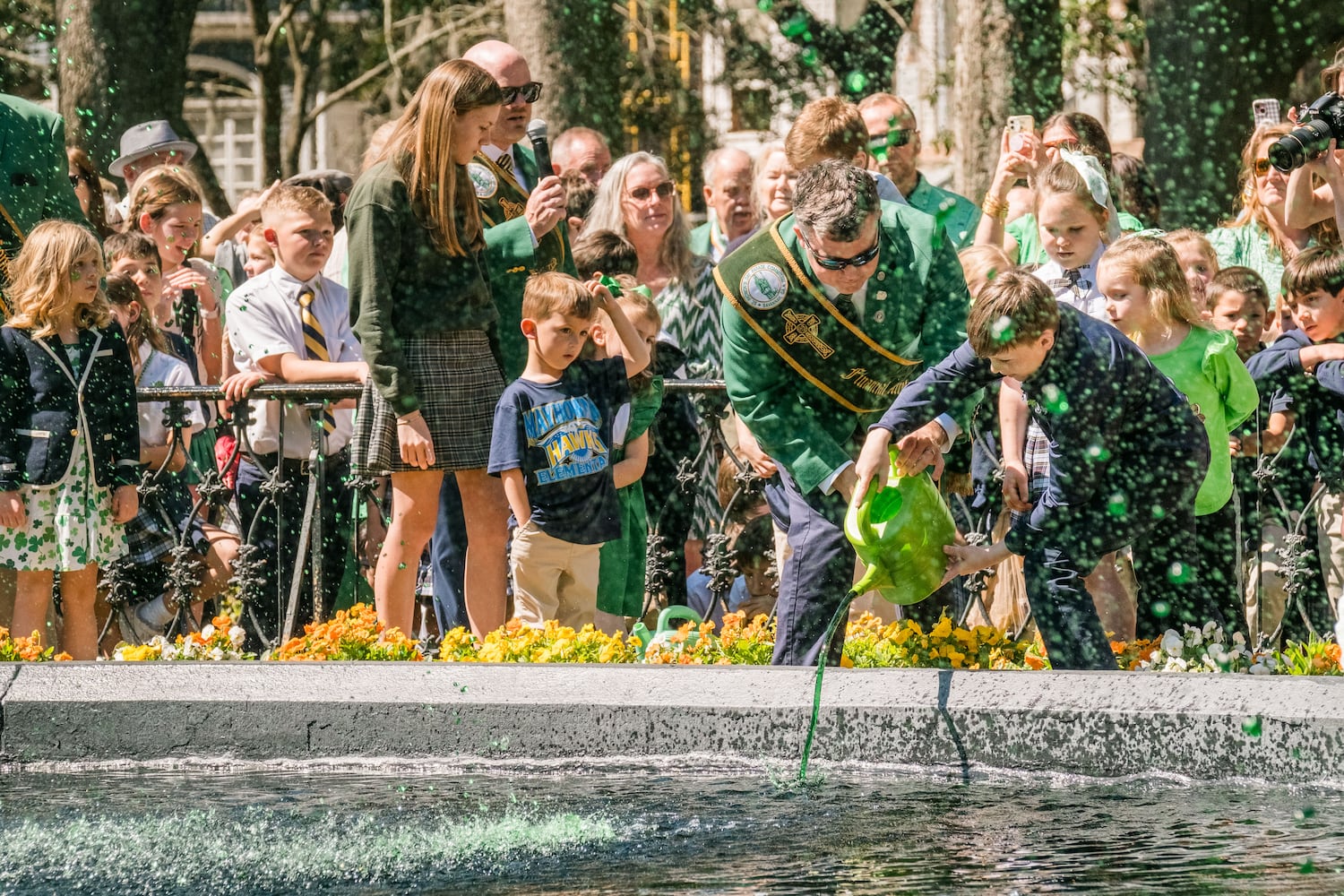 Members of the 2025 St. Patrick’s Day Parade Committee pour green dye into the fountain in Forsyth Park on March 7, 2025 in Savannah, GA. The dying of the fountain marks the beginning of the city’s St. Patrick’s Day festivities. (Justin Taylor/The Atlanta Journal Constitution)