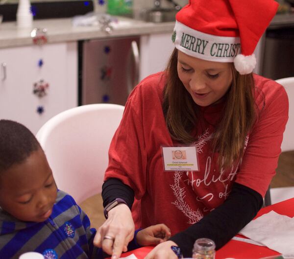 Christi Schenzel, YPL advisory board member, volunteers at United Way Kids Home Initiative Holiday Party during the HoliDAY of Service.