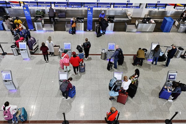 Travelers flying with Southwest Airlines wait in line at Hartsfield-Jackson International Airport in Atlanta on Friday, December 30, 2022. (Natrice Miller/natrice.miller@ajc.com)  