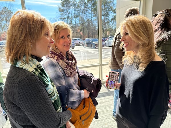 Long-time Fish 104.7 afternoon host Beth Bacall meets with fans Janet (left) and Jeanette Mihoci of Lawrenceville at the station's going away party at Mt. Paran Church Jan. 25, 2025. RODNEY HO/rho@ajc.com