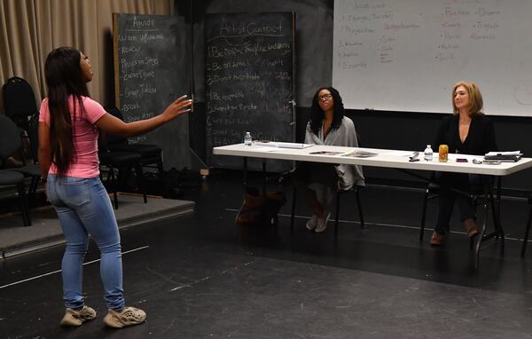 221007 Atlanta, Ga: Jody Feldman (seated right) and casting assistant Assata Amankeechi (seated left) listen to the monologue and short song by actress India Scandrick during auditions at the Alliance Theatre. "These were general auditions. I invite actors in to do monologues and sing (if they are singers) so I can get a sense of their skill level and type. I am looking for actors who are focused, specific in the choices they have made for their character, honest, and who are watchable and comfortable in their bodies. I will often give an actor a [directorial] note or a different circumstance for a second run at their monologue to see if they can take direction. This is really important, as an actor has to be able to incorporate a director's ideas into their work. They need to be directable." Photo of Jody Feldman, Producer and Casting Director at The Alliance Theatre holding live auditions on Friday 10/7/22 morning in the Hammacher Studio, 4th floor of the Woodruff Arts Center. Each actor performs a couple of self-chosen monologues (parts of a play) and possibly a song if they possess that talent. Aging in Atlanta Community profile of Jody Feldman, Producer and Casting Director of the Tony-Award winning Alliance Theatre - she has held the role for 30 years. Photo taken Friday October 7, 2022 at the Alliance Theatre/Woodruff Arts Center - 3rd floor (Hamacher Studio). (CHRIS HUNT FOR THE ATLANTA JOURNAL-CONSTITUTION)