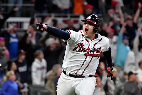 Braves third baseman Austin Riley reacts after hitting a walk-off RBI single, scoring second baseman Ozzie Albies.  Hyosub Shin / Hyosub.Shin@ajc.com 