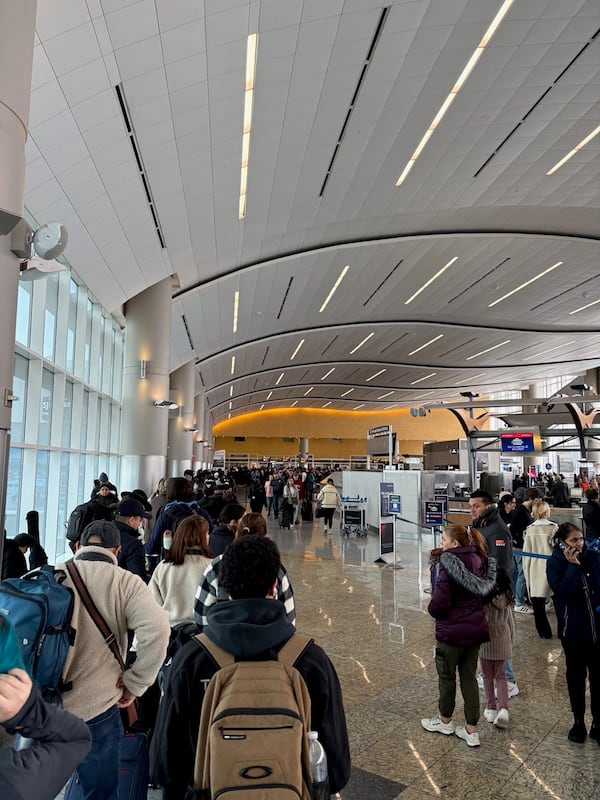 Travelers waited in a long line for the security checkpoint at the international terminal at Hartsfield-Jackson International Airport on Saturday, January 11, 2025. (Emma Hurt / AJC)