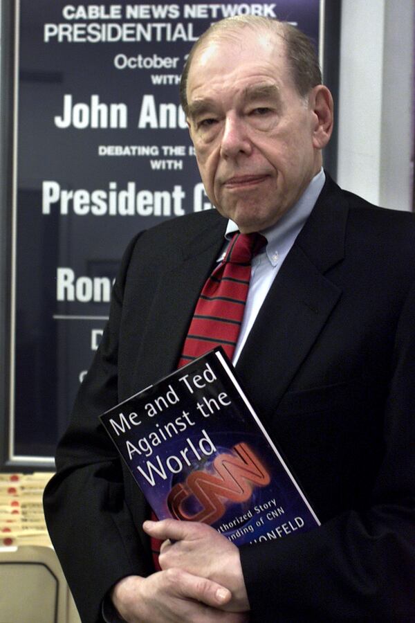 Reese Schonfeld holds a copy of his book 'Me and Ted Against the World: The Unauthorized Story of the Founding of CNN', in his New York office Jan. 30, 2001. In the book, Schonfeld, who got CNN started in 1980 with Ted Turner's money and enthusiam, compiles an entertaining and personal account of how the all-news network came to be, and what's gone wrong since. (AP Photo/Beth A. Keiser)