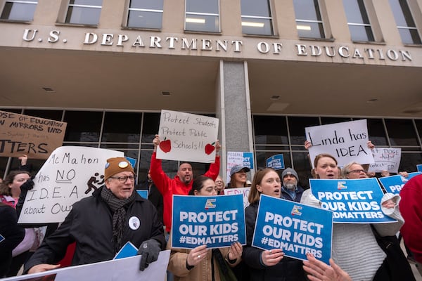 Protestors gather during a demonstration at the headquarters of the Department of Education, Friday, March 14, 2025, in Washington. (AP Photo/Mark Schiefelbein)