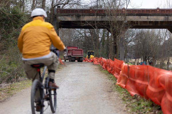 A bicyclist rides past construction on the Beltline at Piedmont Park in Atlanta on Thursday, February 8, 2024. (Arvin Temkar / arvin.temkar@ajc.com)