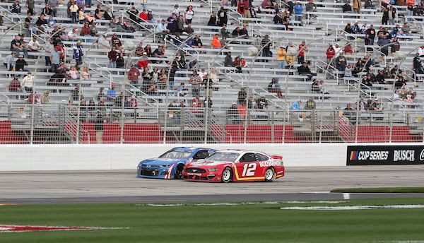 Ryan Blaney's No. 12 car passes Kyle Larson with eight laps remaining on his way to winning the Folds of Honor QuikTrip 500 Sunday, March 21, 2021, at Atlanta Motor Speedway in Hampton. (Curtis Compton / Curtis.Compton@ajc.com)