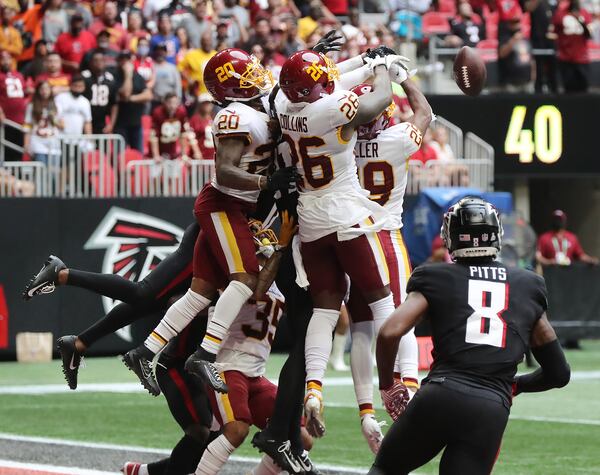 Falcons tight end Kyle Pitts looks on as Washington Football Team defenders knock down a last-second Hail Mary by Matt Ryan into the end zone Sunday, Oct. 3, 2021, at Mercedes-Benz Stadium in Atlanta. Washington held on to win 34-30. (Curtis Compton / Curtis.Compton@ajc.com)