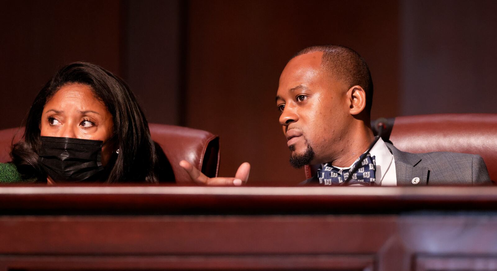 Council members Marci Collier Overstreet (left) and Antonio Lewis confer at an Atlanta City Council meeting. (Bob Andres / robert.andres@ajc.com)