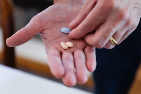 Tom Kerekes shows Trikafta, the drug combination he now takes to treat his cystic fibrosis. The medication, approved by the Food and Drug Administration in October 2019, has transformed the lives of many people with CF. (Natrice Miller/natrice.miller@ajc.com)  