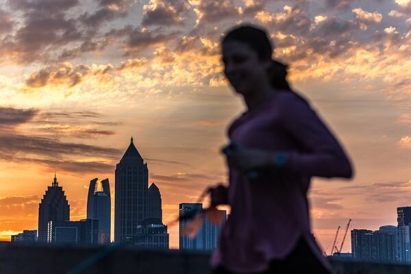 Lauren Adams took her dog Eli for a run along 17th Street near Northside Drive in Atlanta as a dazzling sunrise graced the metro Tuesday morning.

