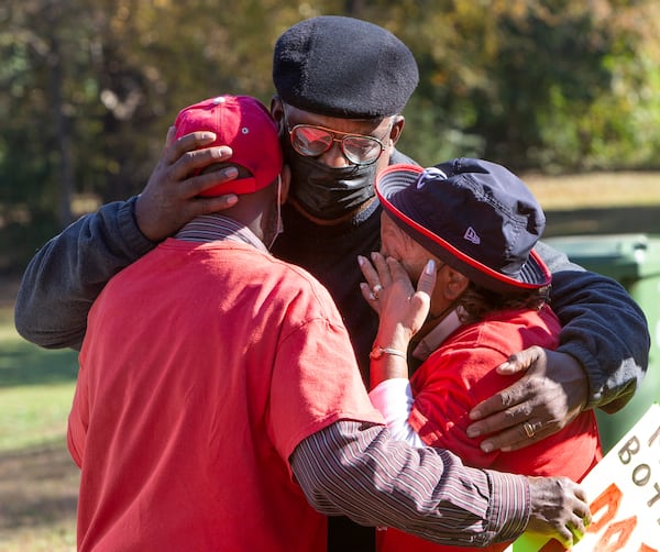 Pastor Dennis Mitchell (center) consoles a visibly upset Robert and Bertha Darden at the rally. The Dardens have been outspoken about their desire to stay in their homes, which the city has tried to take possession of to implement a flooding prevention plan. PHIL SKINNER FOR THE ATANTA JOURNAL-CONSTITUTION