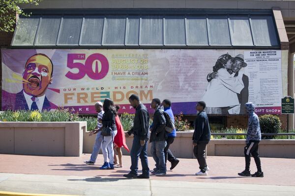 People walk past the King Center while visiting historic Auburn Avenue and the King National Historic Park Wednesday. ALYSSA POINTER/ALYSSA.POINTER@AJC.COM