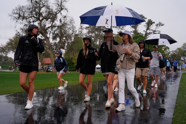 Fans leave the course during a weather delay in the final round of The Players Championship golf tournament Sunday, March 16, 2025, in Ponte Vedra Beach, Fla. (AP Photo/Julia Demaree Nikhinson)