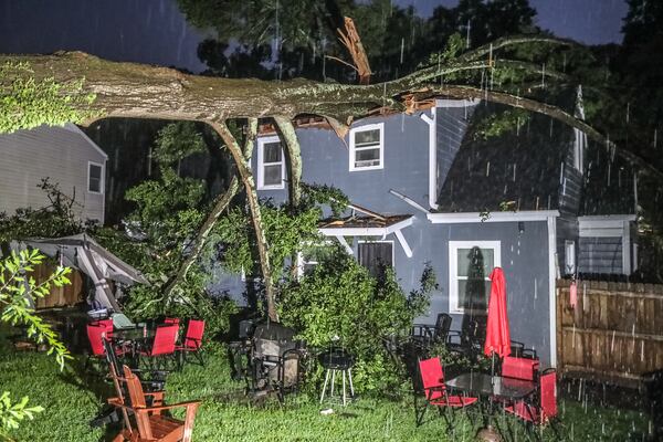 A woman was injured when a tree fell on a house along Charlotte Place in northwest Atlanta early Monday morning.