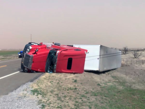 This photo provided by the Oklahoma Highway Patrol shows a tractor-trailer overturned on highway US 183 just south of Hobart, Oklahoma on Thursday, March 13, 2025. (Oklahoma Highway Patrol via AP)