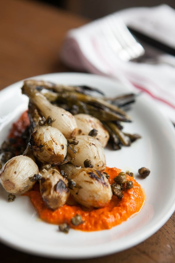 King + Duke’s Coal-Roasted Torpedo Onions with Romesco Sauce. (Styling by chef Layla Walk / contributed by Renee Brock)