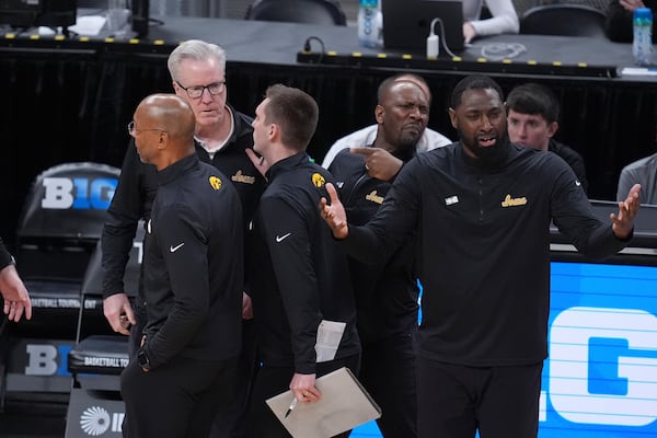 Iowa head coach Fran McCaffery, back left, waits to see if he was ejected against Illinois during the second half of an NCAA college basketball game in the second round of the Big Ten Conference tournament in Indianapolis, Thursday, March 13, 2025. (AP Photo/Michael Conroy)