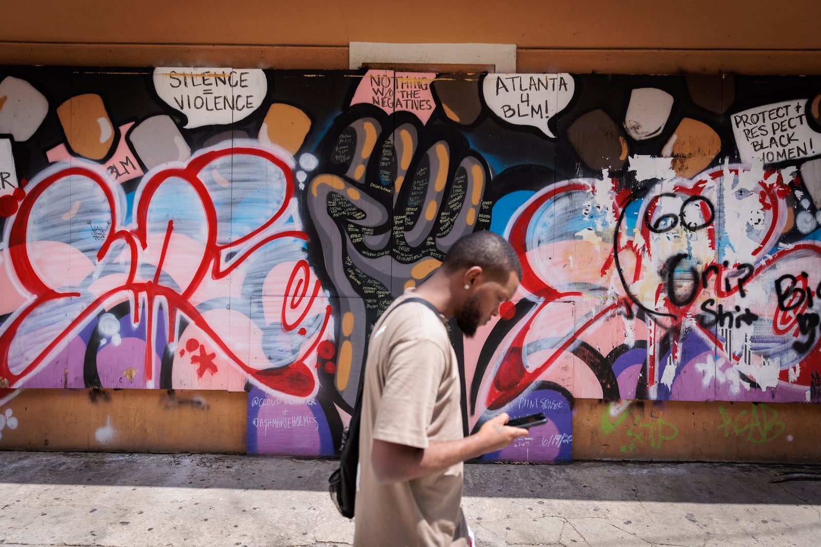 A person walks along Auburn Avenue in Atlanta on Wednesday, July 20, 2022. (Arvin Temkar / arvin.temkar@ajc.com)