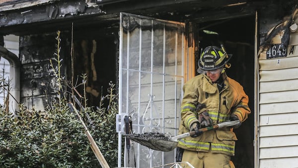 Forest Park firefighter, Bobby Channell on the scene where a man died in a Clayton County house fire early Thursday after he rescued five children from the blaze, officials said. Neighbors reported the fire at the home on Burks Road and Whitley Drive shortly after 2 a.m. Thursday, Forest Park fire Deputy Chief Matt Jackson said. (JOHN SPINK/JSPINK@AJC.COM)