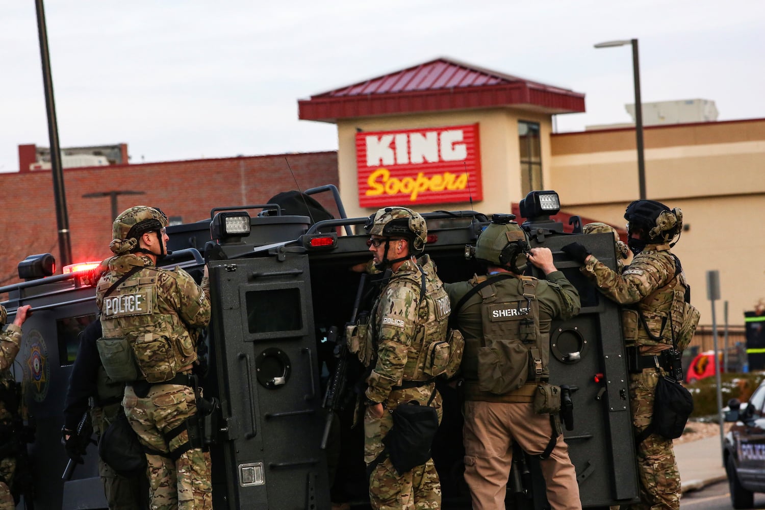 Law enforcement officers in tactical gear are seen at the site of a shooting at a King Soopers grocery store in Boulder, Colorado, March 22, 2021. REUTERS/Kevin Mohatt