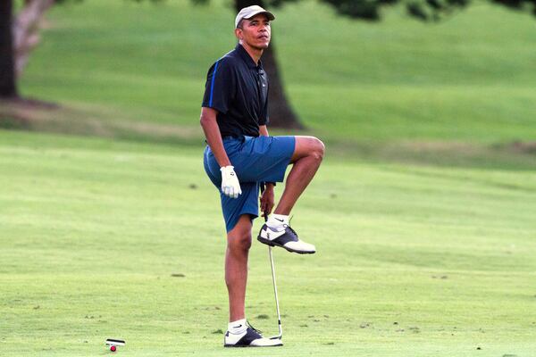 President Barack Obama reacts to his chipped shot as he golfs with Bobby Titcomb, Greg Orme, and Mike Ramos on Monday, Dec. 29, 2014, on the 18th hole of the Mid Pacific Country Club in Kailua, Hawaii during the Obama family vacation. (AP Photo/Jacquelyn Martin) If you see this man on the course, get your bets down. (AP Photo)