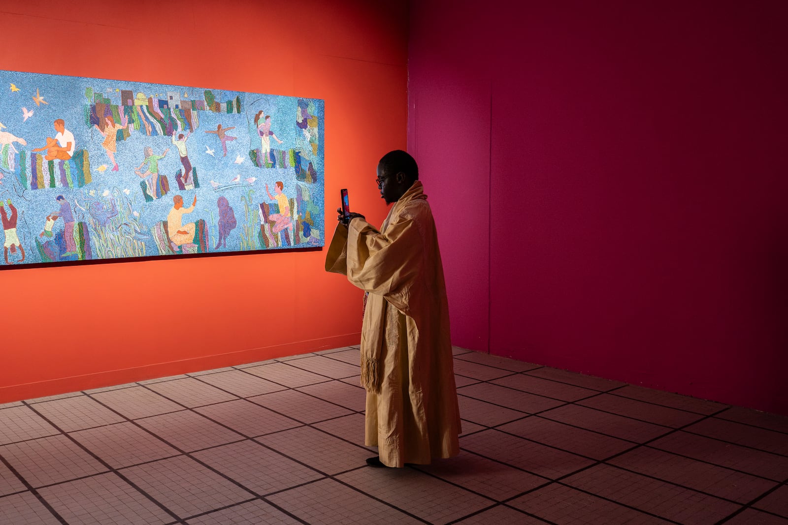 A visitor explores the international exhibit at the Dakar Biennale of Contemporary African Art in Dakar, Senegal, Friday, Nov. 8, 2024. (AP Photo/Annika Hammerschlag)