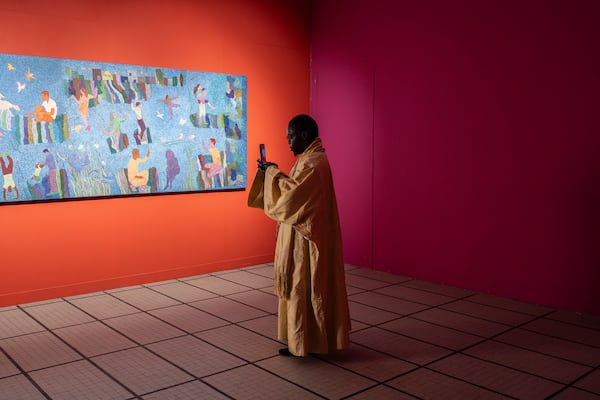 A visitor explores the international exhibit at the Dakar Biennale of Contemporary African Art in Dakar, Senegal, Friday, Nov. 8, 2024. (AP Photo/Annika Hammerschlag)