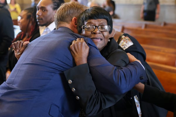 Lutricia Henderson Gray, facing, hugs Michael Holmes after murder charges were dropped against Clarence Henderson, Lutricia’s father, in a historic court hearing at the Carroll County Courthouse, Thursday, March 2, 2023, in Carrollton, Ga. Michael Holmes is the cousin of victim Carl “Buddy” Stevens, Jr.. Jason Getz / Jason.Getz@ajc.com)