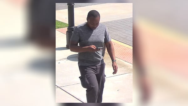 The man seen in this surveillance photo has been identified as a person of interest in the case of a 31-year-old Decatur man found dead inside his apartment Wednesday.