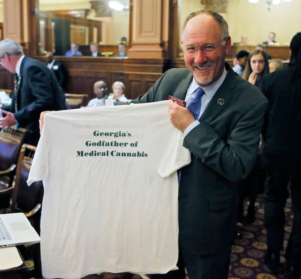 State Rep. Allen Peake, R-Macon, who has sponsored medical marijuana bills during his terms in office, shows off a T-shirt that families he helped presented to him on Thursday. BOB ANDRES /BANDRES@AJC.COM