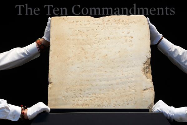 The oldest complete tablet of the Ten Commandments, weighing 115-pounds and approximately 1,500 years old, is displayed at Sotheby's, in New York, Monday, Dec. 9, 2024, where it is to be offered for auction in a single lot sale, Dec, 18, 2024. (AP Photo/Richard Drew)