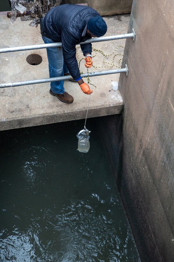 Plant manager Kenneth Gobin pulls a water sample for COVID-19 testing at the Snapfinger Creek Wastewater Treatment Plant Friday, March 18, 2022.  STEVE SCHAEFER FOR THE ATLANTA JOURNAL-CONSTITUTION