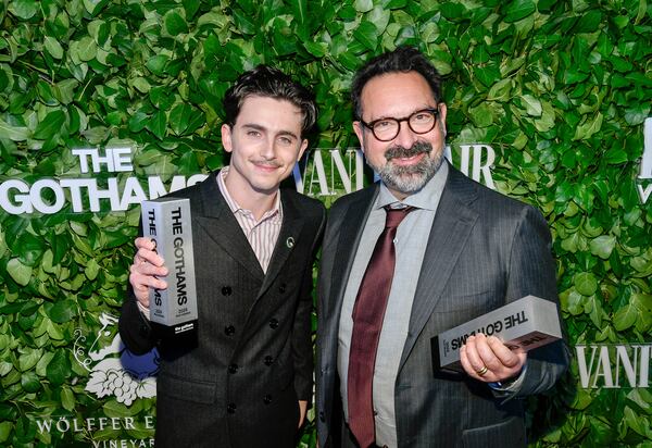 Timothee Chalamet, left, and James Mangold pose with the visionary tribute award for "A Complete Unknown" during The Gothams Film Awards at Cipriani Wall Street on Monday, Dec. 2, 2024, in New York. (Photo by Evan Agostini/Invision/AP)