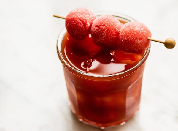 Our Watermelon Iced Tea with Boozy Option is garnished with frozen melon balls; it was inspired by drink at 1Kept Kitchen & Bar in Buckhead. The uplifting summer libation is shown here with Fried Watermelon Rind and Alon Shaya’s Harissa. (Photo contributed by Henri Hollis; food styling by Wendell Brock)