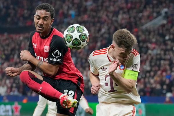 Leverkusen's Arthur, left, duels for the ball with Bayern's Joshua Kimmich during the Champions League round of 16 second leg soccer match between Bayer Leverkusen and Bayern Munich at the BayArena in Leverkusen, Germany, Tuesday, March 11, 2025. (AP Photo/Martin Meissner)